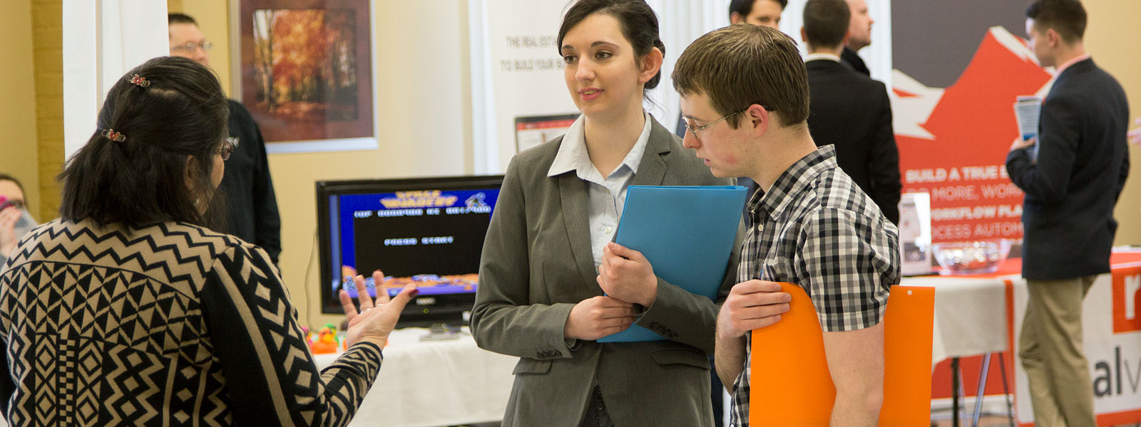 student interacts with professional at career fair