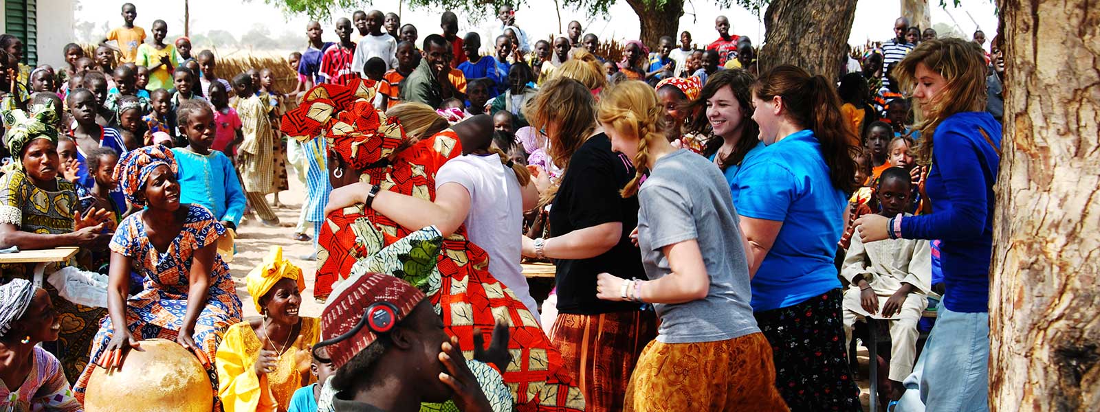 students learning African dance with villagers while on mission trip