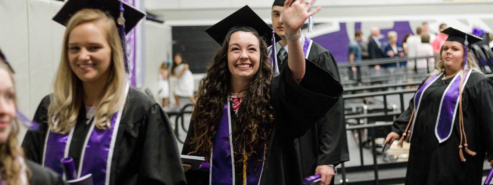 smiling student in commencement processional