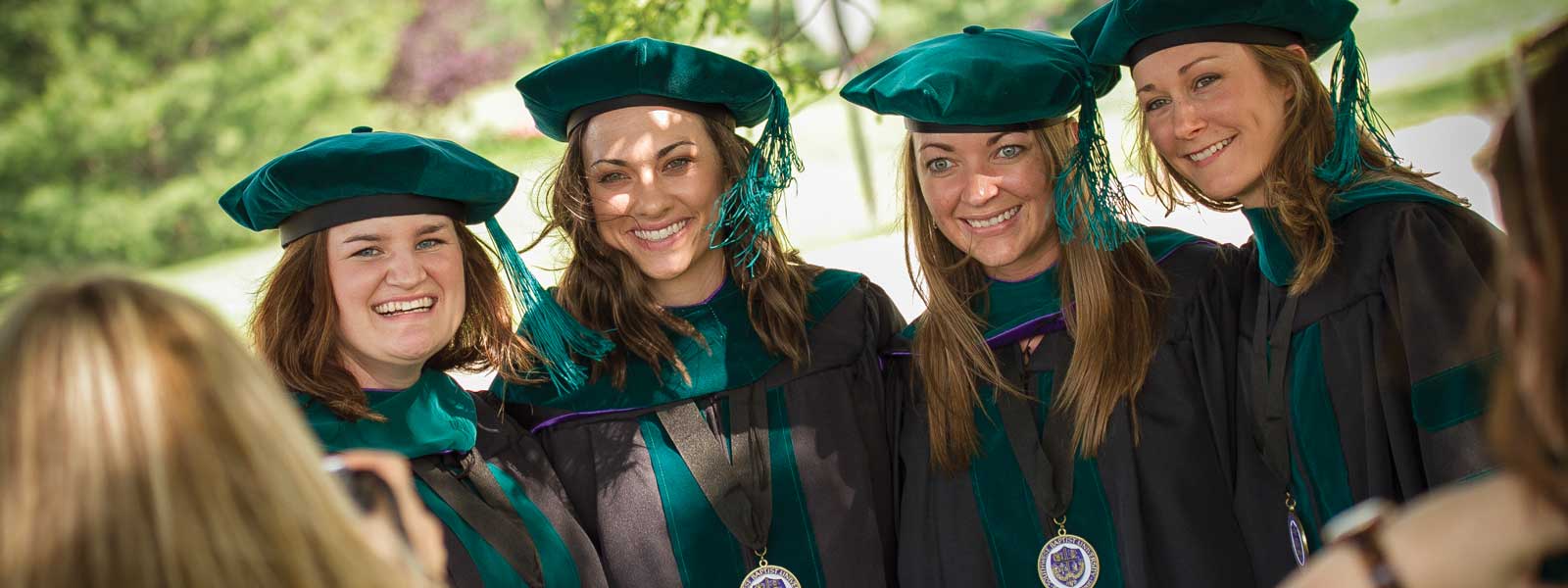 physical therapy graduates pose for photo