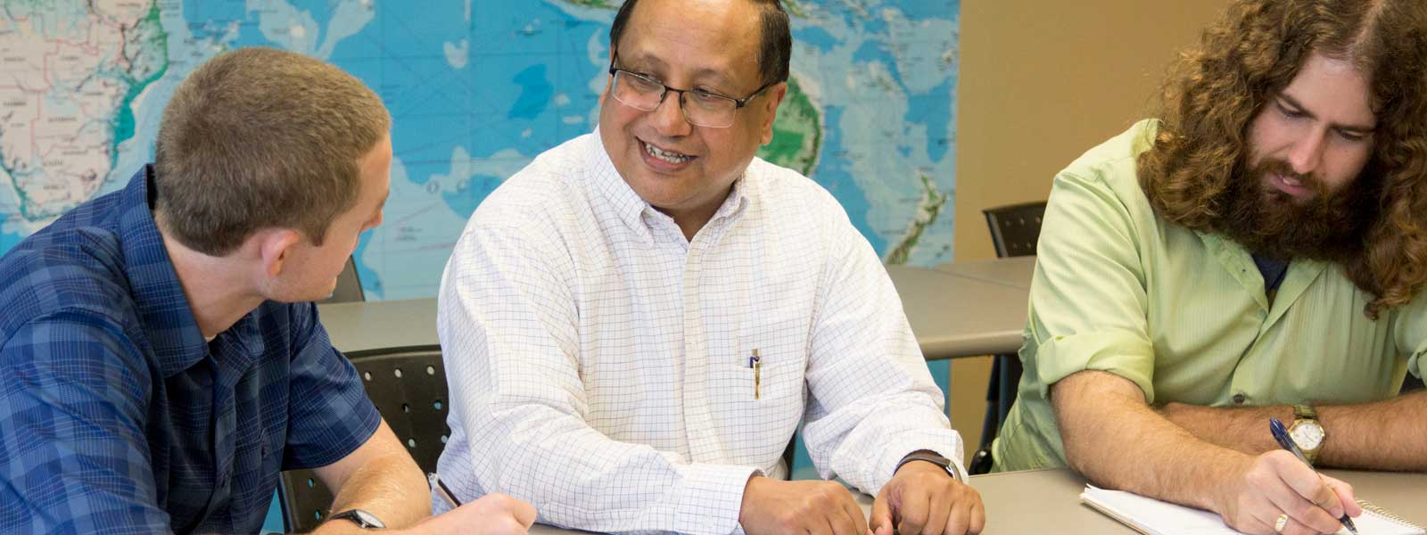 professor meets with two students in his office