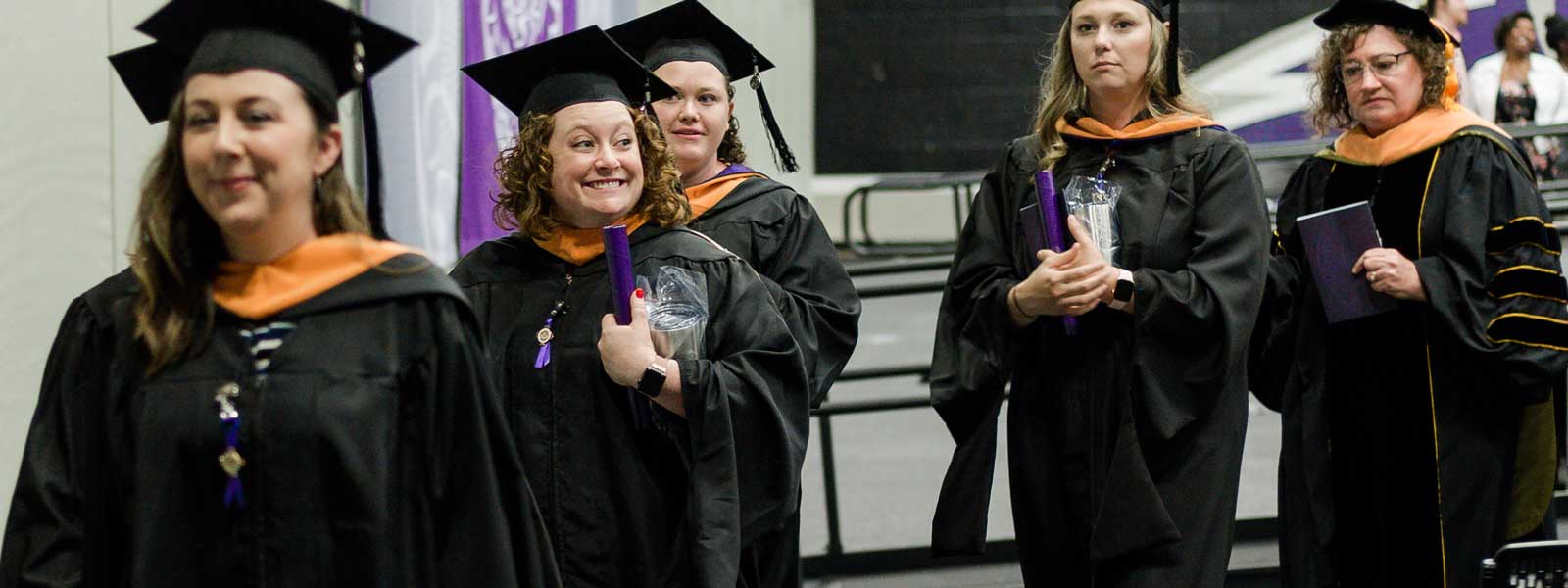 master of nursing graduates leave commencement carrying diplomas